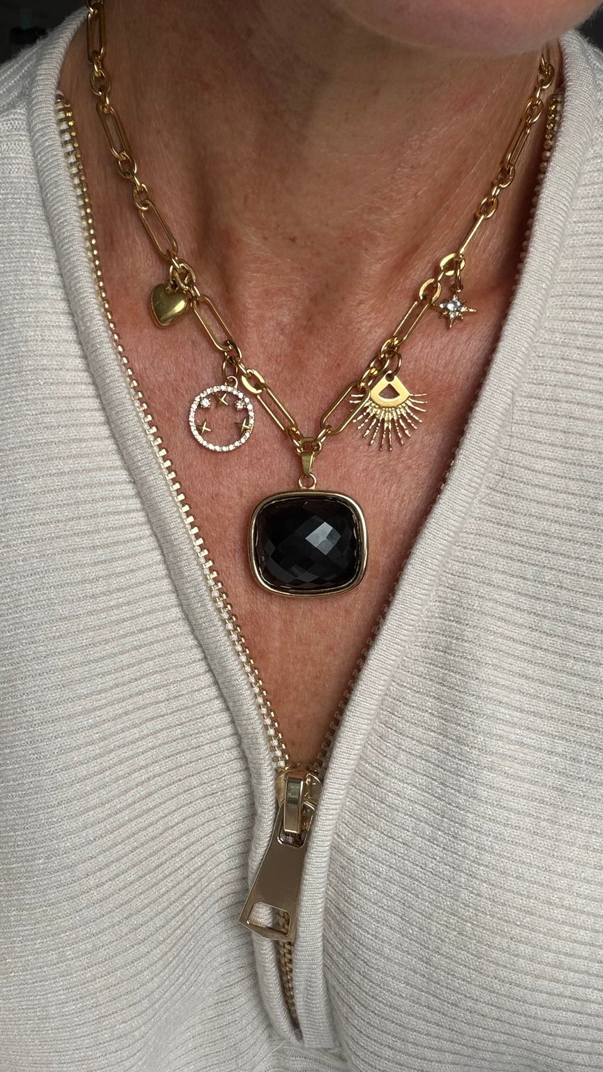 The Margot necklace worn with white knit top